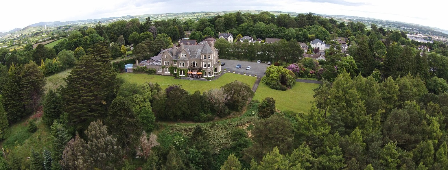 The house and its wooded twelve-acre estate from the air