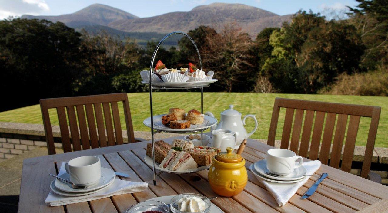 Mourne Honey afternoon tea laid out on the terrace before the mountains