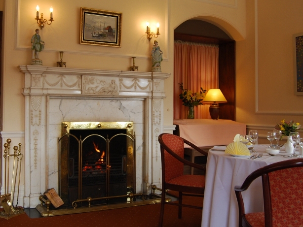 A table set beside the open marble fireplace