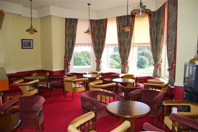 The lounge bar's armchairs gathered at the bay windows over the garden