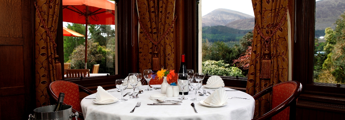 A set table in the Oak Restaurant's window, the Mourne Mountains beyond the glass