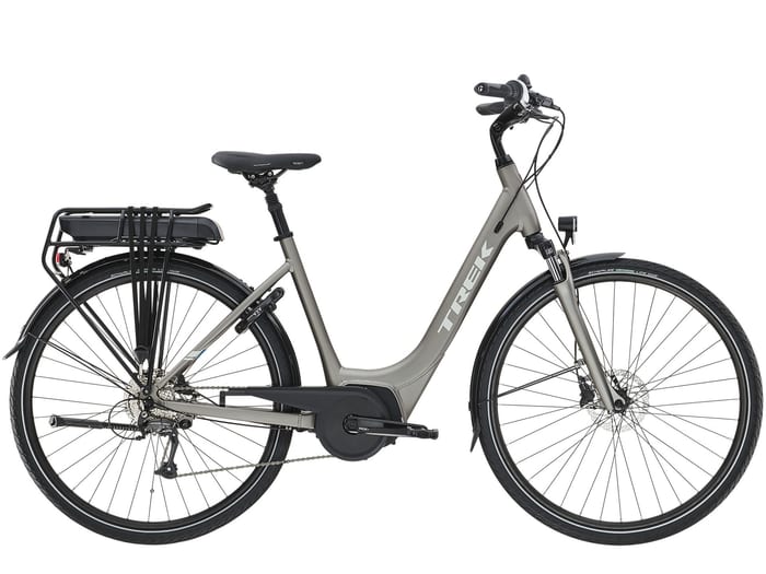 A silver Trek step-through electric bike with a rear rack battery