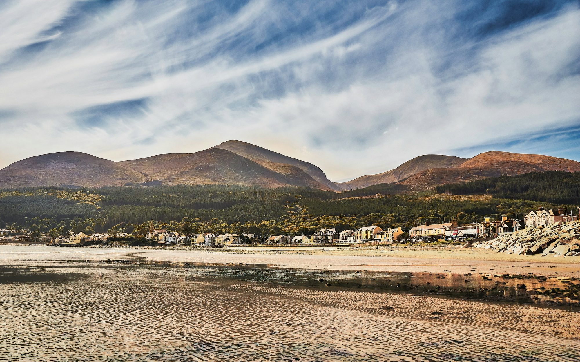Low tide on Newcastle beach with the town and Mourne Mountains beyond
