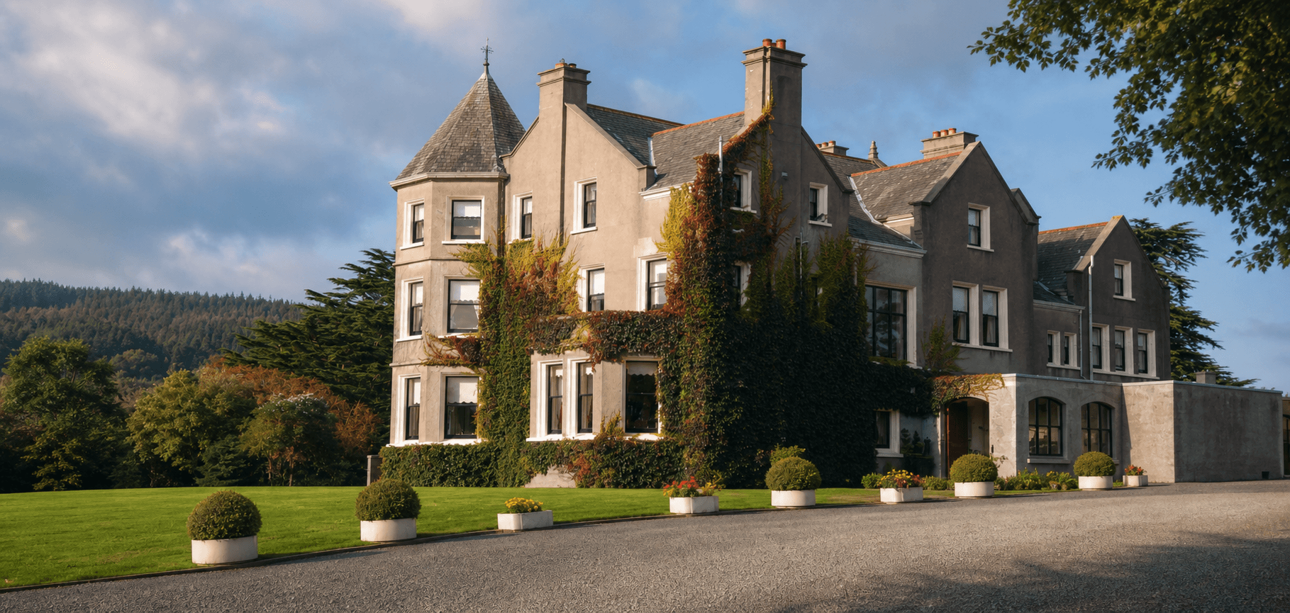 Enniskeen Country House Hotel — rendered gabled façade, turret and ivy