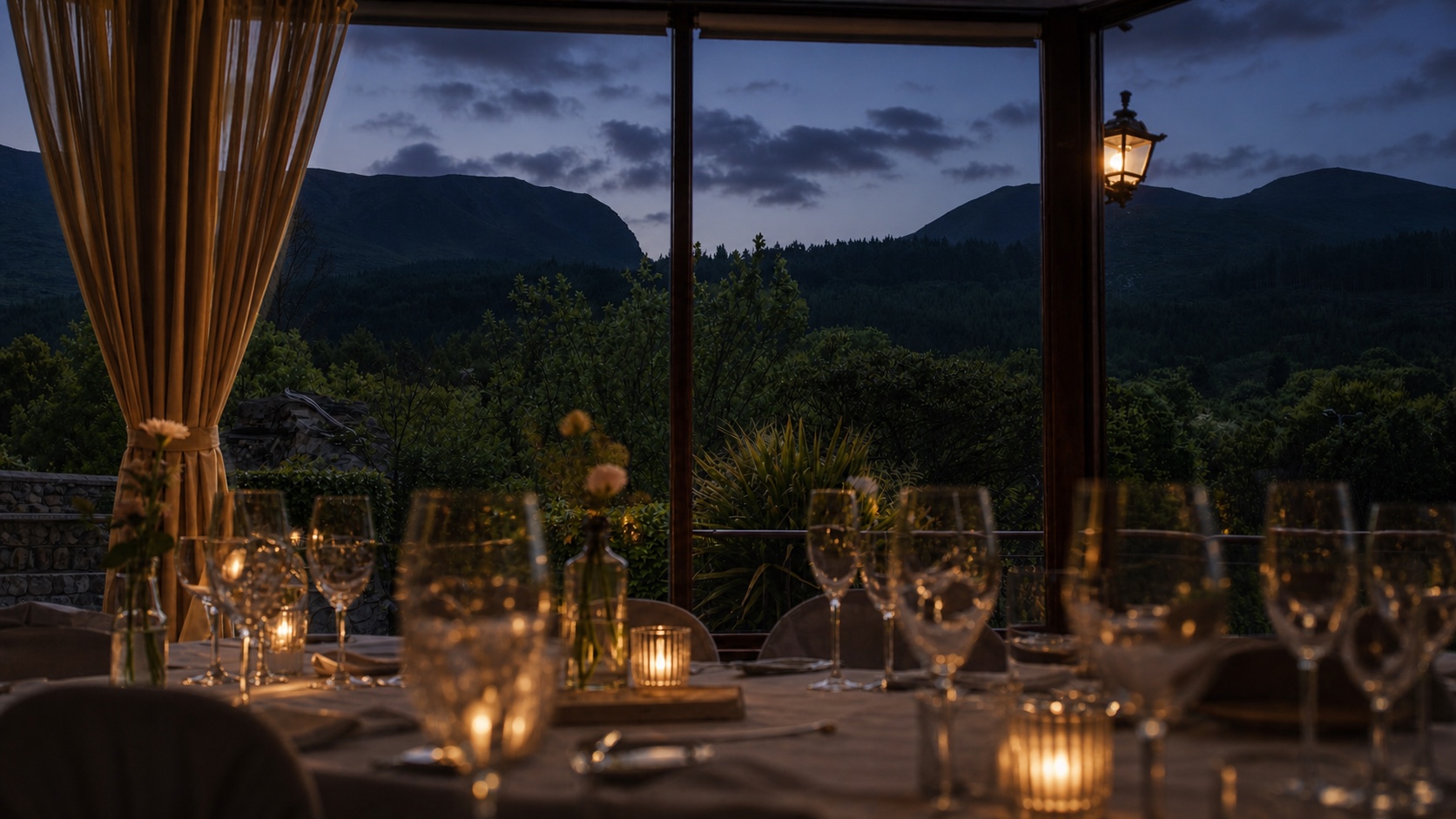 Hugh McCann's dining room at dusk, with table settings and the Mourne profile beyond the windows
