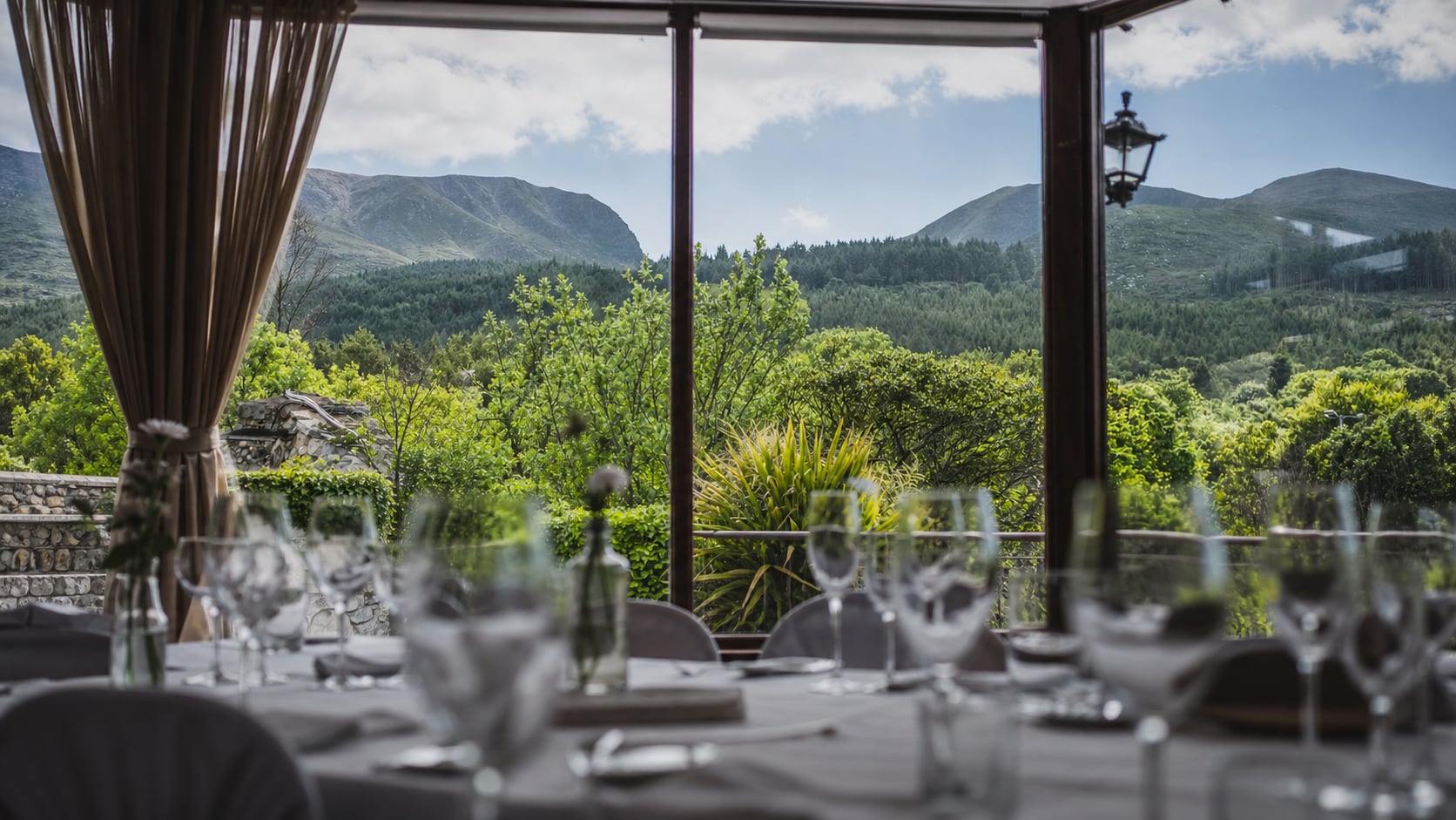 Hugh McCann's dining room by day, looking through broad windows towards the Mournes