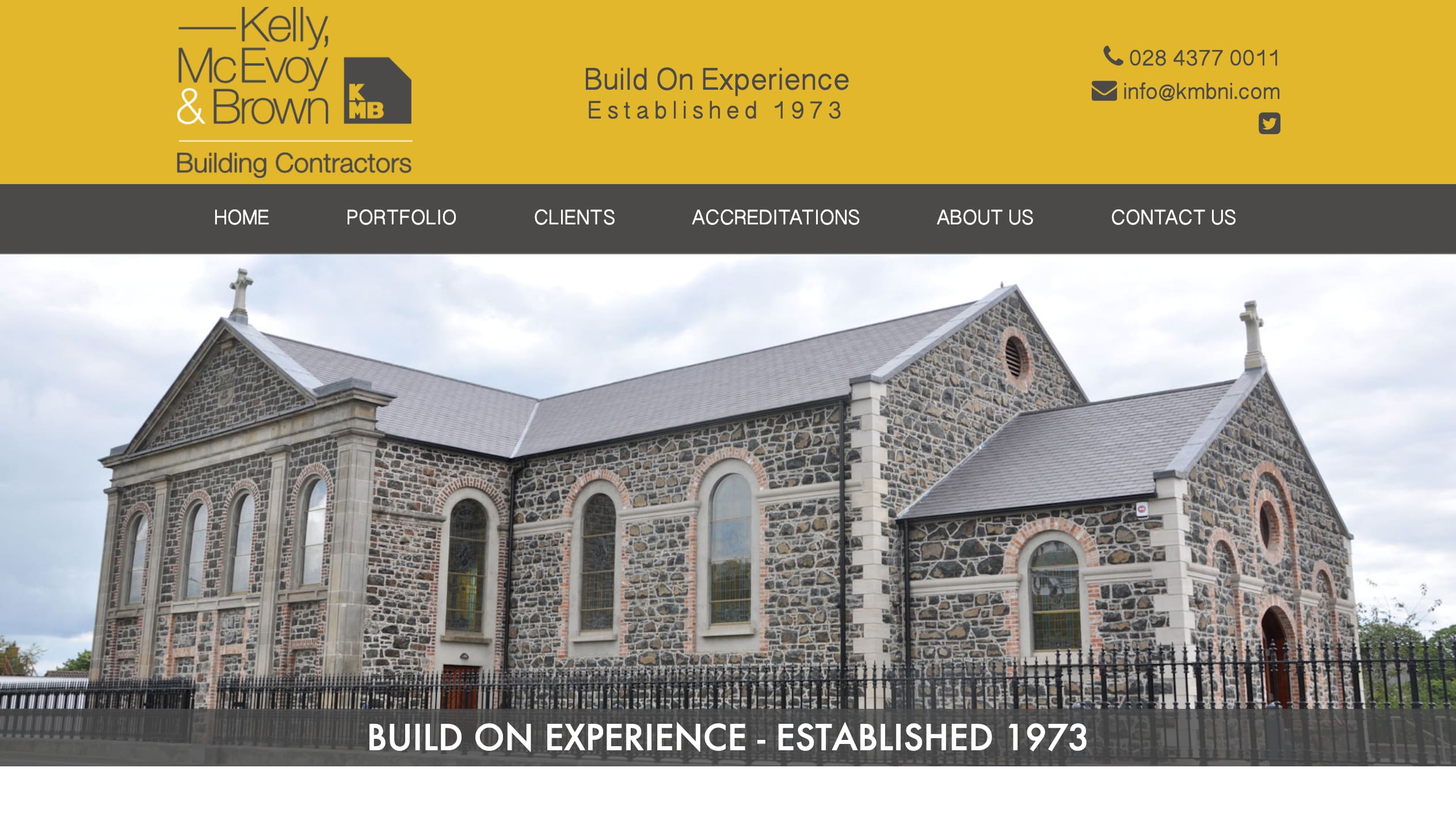 Kelly, McEvoy & Brown's current homepage: a small hand-built site opening on a rotating carousel, with the portfolio reached through a sector-by-sector menu