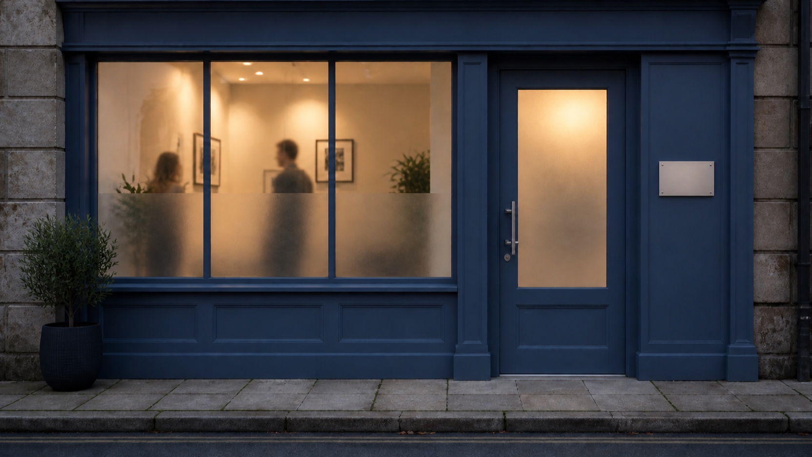 AI-generated indicative scene of the same frosted-glass door warmly lit with two soft staff silhouettes inside
